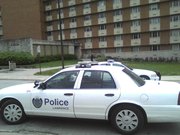 Lawrence Police and KU Public Safety officers surround McCollum Hall in response to a report of an armed subject in the building. Law enforcement has established a perimeter around the building.