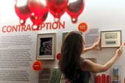 Sarah Forbes, curator of the Museum of Sex, arranges a display packet of “the pill” from 1979 in the museum’s latest exhibit May 5 in New York. Today is the 50th anniversary of the world’s first oral contraceptive.