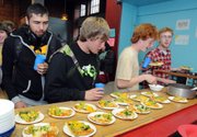 from left, Nick Widomski, Wyatt Kail, Jesse Kail and Matt Frye line up for pizza at the after-school supper program last month at the Brattleboro Boys & Girls Club in Brattleboro, Vt. The program, subsidized by the U.S. Department of Agriculture, provides nutritious meals to children in communities where more that half of households fall below the poverty level.