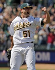 Oakland starting pitcher Dallas Braden celebrates throwing a perfect game against Tampa Bay on Sunday in Oakland, Calif.