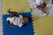 A baby with an amputated leg due to an injury sustained during the earthquake lies on a mat April 22 in the Enfant Jesus orphanage in Malpasse, Haiti. The catastrophic earthquake that rendered at least 1.3 million of its 9 million people homeless was the final push over the edge for families that could barely afford to feed their children before.