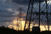 Electrical power generation lines are seen below storm clouds in this May 8 photo in a rural field near Newtown, Pa. The Labor Department reported Wednesday that consumer prices edged down 0.1 percent last month, reflecting a big fall in energy prices.