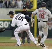 Detroit pitcher Armando Galarraga (58) covers first base as Cleveland’s Jason Donald, right, runs to the base and umpire Jim Joyce looks on. Joyce called Donald safe, costing Galarraga his bid for a perfect game with two outs in the ninth on Wednesday in Detroit.