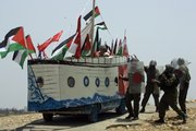 Israeli soldiers, right, try to stop a vehicle decorated in a shape of a ship by Palestinian, Israeli and international protesters. The vehicle depicting one of the ships of the humanitarian flotilla that tried to get to Gaza this week was used during a protest Friday in the outskirts of the West Bank village of Bilin, near the city of Ramallah.Tensions are high in the aftermath of an Israeli naval raid targeting the aid flotilla to Gaza that killed nine pro-Palestinian activists, mostly Turks, in the ensuing clash.