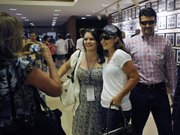 Former Alaska Gov. Sarah Palin poses for a photo as her husband, Todd Palin, right, stands behind her. The Palins attended the Belmont Stakes on Saturday in Elmont, N.Y. The horse First Dude, who finished third, is named for Todd Palin.