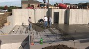 Concrete is poured at the foundation of the Armstrongs’ home, which features a geothermal system, foam insulation and heat recovery ventilation.