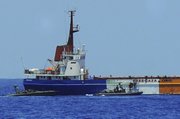 Israeli army and navy soldiers on boats are seen approaching the Gaza-bound 1,200-ton Rachel Corrie aid ship in this image made from video released by the Israeli Defense Force on Saturday. Israeli forces seized the Gaza-bound aid vessel swiftly and without meeting resistance, preventing it from breaking a naval blockade of the Hamas-ruled territory days after a similar effort turned bloody.