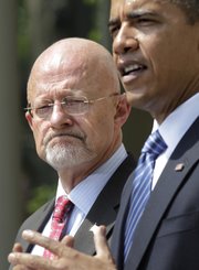 President Barack Obama announces James Clapper, left, as Director of National Intelligence, his choice to oversee the nation’s 16 spy agencies, during a ceremony Saturday in the Rose Garden at the White House in Washington.