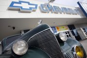 A 1939 Chevrolet coupe is parked in this Sept. 23, 2009, file photo outside a Chevrolet dealership in Englewood, Colo. General Motors Co. on Thursday backed off a “poorly worded” internal memo that asked employees to refer to the brand only as “Chevrolet” in an effort to create consistency.