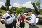 Korean War veterans Henry F. Reed, 78, of Butte, Mont., left, and Lynn A. Freeman, 87, of Concord, Calif., right, talk as veterans of the 2nd Infantry Division and the 5th Regimental Combat Team, listen during a tour of a war monument June 2 at Dabu-Ri, South Korea. Some were among the troops who held out in mid-1950 on the last-ditch “Pusan Perimeter,’’ staving off final North Korean conquest of the south.