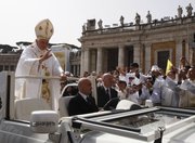 Pope Benedict XVI leaves after celebrating a Mass on Friday in St. Peter’s Square concelebrated by 15,000 white-robed priests, all marking the end of the Vatican’s Year of the Priest.