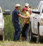 A woman cries Saturday outside the family center in Lodi, Ark., while waiting for word about relatives missing after a flash flood swept through a popular campground, killing numerous people. Rescue crews took to kayaks, horseback and ATVs on Saturday to resume the desperate search for about two dozen campers still missing.