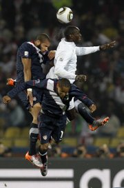 England’s Emile Heskey, top right, vies for the ball with United States’ Oguchi Onyewu, left, and United States’ Ricardo Clark during the World Cup Group C soccer match. The United States tied England, 1-1, on Saturday in Rustenburg, South Africa.
