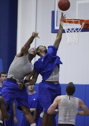 Kansas forward Markieff Morris gets off a shot around Thomas Robinson, left, during Bill Self's basketball camp Tuesday, June, 15, 2010 at the Horejsi Center.