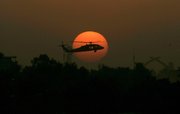 A U.S. Army Black Hawk helicopter flies as the sun sets over Baghdad in this Oct. 30, 2007, file photo. The State Department wants its own combat-ready protection force for diplomatic personnel in Iraq after U.S. military forces leave the country as planned at the end of 2011.