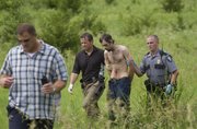Lawrence police officers and Douglas County sheriff deputies detain a suspect in a stabbing incident along the bike path near Clinton Lake. William E. Nichols was arrested after a 15-minute manhunt in the area between the YSI softball fields and the Clinton Lake Dam Wednesday, June 16, 2010.