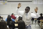 Algebra teacher LaMar Queen wears his rap glasses as he sings along with his Algebra students May 26 at the Los Angeles Academy in Los Angeles. The Los Angeles Unified School District teacher has won two awards for his innovative teaching method, by creating rap songs out of math concepts.