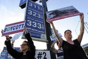 Elaine Jesmer, left, and Heather Crosson, both of Los Angeles, hold signs during a protest against BP PLC organized by Moveon.org June 8 outside an ARCO gas station in Los Angeles. ARCO is a subsidiary of British Petroleum.