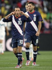 United States forward Landon Donovan, left, celebrates with teammate Clint Dempsey after scoring a goal during a World Cup soccer match against Slovenia last Friday. The U.S. will play its final group game Wednesday against Algeria.