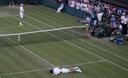 John Isner of the U.S., left, smiles at Nicolas Mahut of France as he lies on the court on Wednesday at Wimbledon.