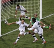 After scoring the winning goal, U.S. soccer player Landon Donovan, front left, celebrates with team members Clint Dempsey, back left, and Edson Buddle, front right. The U.S. beat Algeria, 1-0, in its World Cup Group C soccer match on Wednesday in Pretoria, South Africa, to advance to the second round.