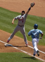 St. Louis first baseman Albert Pujols (5) leaps to make a catch forcing Kansas City’s Jose Guillen out at first. The Cardinals defeated the Royals, 5-3, on Saturday in Kansas City, Mo.