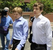Tim Foley, 20, left, and his brother Alex, 16, leave federal court Thursday after a bail hearing for their parents, Donald Heathfield and Tracey Lee Ann Foley, in Boston, who are among 11 people accused of trying to infiltrate U.S. policymaking circles.