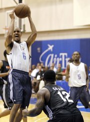Oklahoma City’s Eric Maynor (6) takes a shot over Charlotte’s Sherron Collins during the second quarter of an NBA summer league game Tuesday in Orlando, Fla.