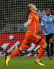 The Netherlands’ Arjen Robben celebrates after scoring the third goal in a 3-2 victory over Uruguay on Tuesday in Cape Town, South Africa.