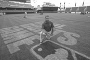Cincinnati Reds head groundskeeper Doug Gallant poses on the field with the fading sign for May’s Civil Rights baseball game held at Great American Ball Park in Cincinnati. As the Cincinnati Reds’ head groundskeeper, Gallant has some advice on how to improve your lawn without making it a full-time job.