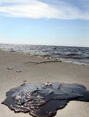 Oil is seen on the beach in Waveland, Miss., Thursday as oil from the Deepwater Horizon spill continues to wash ashore in Harrison and Hancock counties, causing some beaches to be closed.