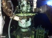 In this image taken from video provided by BP PLC, the arms of a remotely operated vehicle works Saturday on the well head at the Deepwater Horizon oil spill site in the Gulf of Mexico. Robotic submarines removed the cap from the gushing well on Saturday, beginning a period of at least two days when oil will flow freely into the sea. It’s the first step in placing a tighter dome that is supposed to funnel more oil to collection ships.