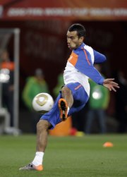 Netherlands’ Giovanni van Bronckhorst kicks the ball during a training session on Saturday at Soccer City Stadium in Johannesburg. Van Bronckhorst’s squad will take on Spain in the World Cup final today.