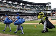 Chicago White Sox mascot Southpaw, right, uses a broom to sweep away the Royals after the White Sox claimed a 15-5 rout Sunday in Chicago.