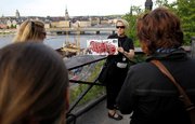 Tour guide Eva Palmqvist, center, shows a map of the island of Sodermalm during a Stieg Larsson tour in Stockholm, Sweden.