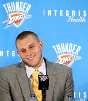 Cole Aldrich reacts with a smile as he answers questions during a news conference Monday at the Thunder practice facility in Oklahoma City.