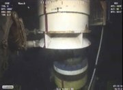 A new containment cap is lowered over the broken wellhead at the site of the Deepwater Horizon oil spill Monday in the Gulf of Mexico in this image taken from video provided by BP. Deep-sea robots swarmed around BP’s ruptured oil well Monday in a delicately choreographed effort to attach the tighter-fitting cap that could finally stop crude from gushing into the Gulf of Mexico.