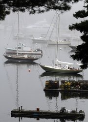 Boats are seen in the fog-shrouded Northeast Harbor in Maine. The president is scheduled to visit Mt. Desert Island this coming weekend.