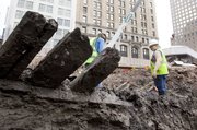Planks from a 32-foot-long 18th century ship stick out of the mud Thursday at the World Trade Center site in New York.