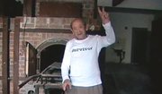 Holocaust survivor Adolek Kohn flashes the “V” for victory sign as he stands in front of one of the ovens at the Auschwitz death camp in Poland in this undated image taken from video.