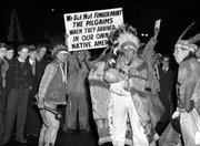 Iroquois Indians who were born in Canada march Dec. 26, 1940, through the main street of Buffalo, N.Y., carrying signs protesting that the U.S. pilgrim fathers were not required to be fingerprinted. They registered as aliens. An American Indian lacrosse team’s refusal to travel on passports not issued by the Iroquois confederacy goes to the heart of one of the most sensitive issues in Indian Country: sovereignty.