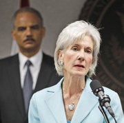 Health and Human Services Secretary Kathleen Sebelius talks to reporters during a news conference as Attorney General Eric Holder looks on Friday in Miami. Federal authorities said they are conducting the largest Medicare fraud bust ever in five different states and arrested dozens of suspects accused in scams totaling $251 million.