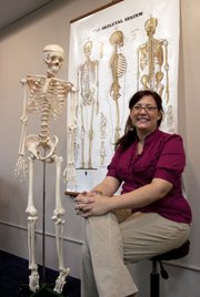 Olivia London-Webb, an instructor at MTTI Wellspring in Lawrence, is one of two local massage therapists planning to teach pediatric therapeutic massage at an orphanage in Vietnam this December.