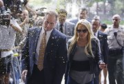Confetti flies as Lindsay Lohan and an unidentified man arrive at the Beverly Hills courthouse on Tuesday.
