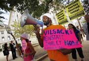 Protesters rally outside the Department of Agriculture building Wednesday in Washington, D.C., in support of Shirley Sherrod.
