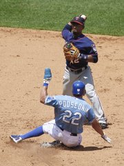 Minnesota second baseman Alexi Casilla, back, prepares to throw to first over Kansas City’s Scott Podsednik to complete a double play. After the Royals’ 6-4 loss on Wednesday in Kansas City, Mo., they traded Podsednik to the Los Angeles Dodgers for two minor leaguers.