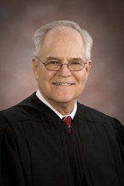Kansas Supreme Court Chief Justice Robert E. Davis announced Tuesday morning that he would resign immediately because of health reasons.