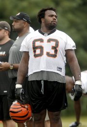 Cincinnati Bengals guard Bobbie Williams (63) looks on during football training camp July 29 in Georgetown, Ky. An analysis of league rosters shows the number of 300-pounders has risen dramatically over the decades.