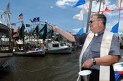 The Rev. Jervis Burns blesses fishing boats docked Sunday in Bayou Delarge in Theriot, La., during the pre-shrimp season tradition known as the “Blessing of the Boats.” Louisiana fishermen are hoping to once again fish for shrimp when the season officially opens next Monday.