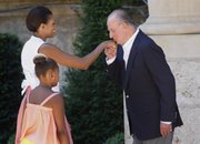 Spain’s King Juan Carlos, right, welcomes U.S. first lady Michelle Obama and daughter Sasha, 9, on their arrival Sunday at the Marivent Palace in Palma de Mallorca, Spain.